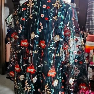 A very cute see through cardigan size large black floral